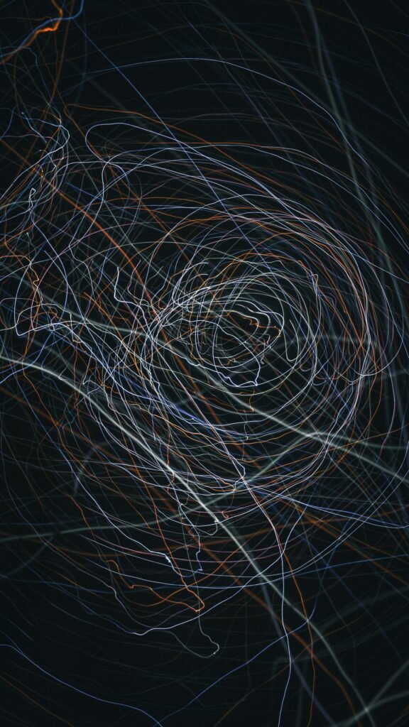 Captivating abstract with swirling light trails in a dark setting, creating a dynamic visual effect.